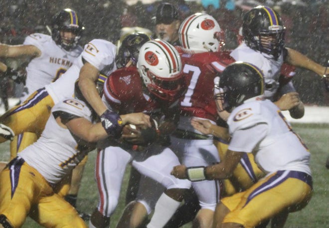 A group of Hickman players attempt to bring down Jefferson City running back Maleek Jackson during the Kewpies' 19-7 defeat to the Jays Friday night in Jefferson City. [Briar Napier/Special to the Tribune]