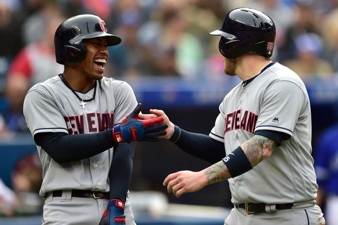 Cleveland Indians' Roberto Perez, right is congratulated by Francisco Lindor after scoring a run against the Toronto Blue Jays during the third inning of a baseball game in Toronto, Saturday, Sept .8, 2018. (Frank Gunn/The Canadian Press via AP)