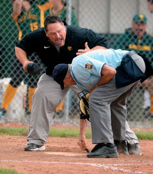 In this June 9, 2015, file photo, Deer Lakes High School softball coach Craig Taliani argues with the home plate umpire after his team's runner was ruled out at home trying to advance on a wild pitch against Cambridge Springs High School during the PIAA Class AA softball semifinal, at Slippery Rock University in Slippery Rock, Pa. An Oklahoma man is leading the charge to stamp out the intolerable behavior that referees must endure at every stage of sports, from youth leagues to the adult level. This is an issue we all need to get behind, because there could come a day when no one is willing to officiate the games we play. [Jack Hanrahan/Erie Times-News]