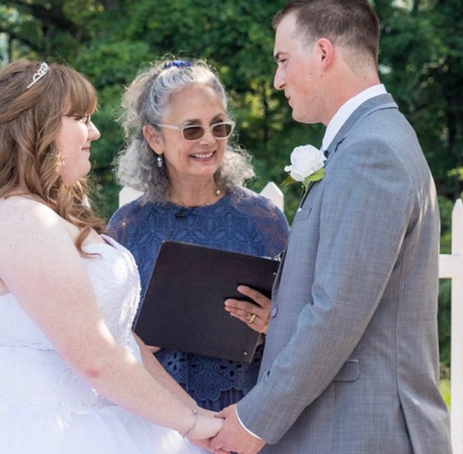 Lois Heckman officiates a wedding for a young couple. Keeping your guests, and each other, engaged in your ceremony, can be as important as the wedding itself. [GARTH WOODS PHOTO]