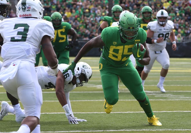 Oregon's Kano Dillon breaks the first of several attempted tackles on his way to a touchdown during the second quarter against Portland State. [Chris Pietsch/The Register-Guard]