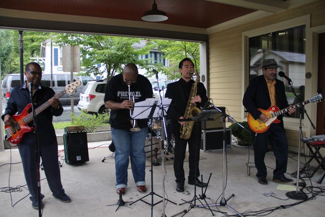 Bobby Kyle, right, and his band had a happy crowd, some of whom danced in the rain in front of Ambience Furniture and Antiques. He did a no-break two hour set.