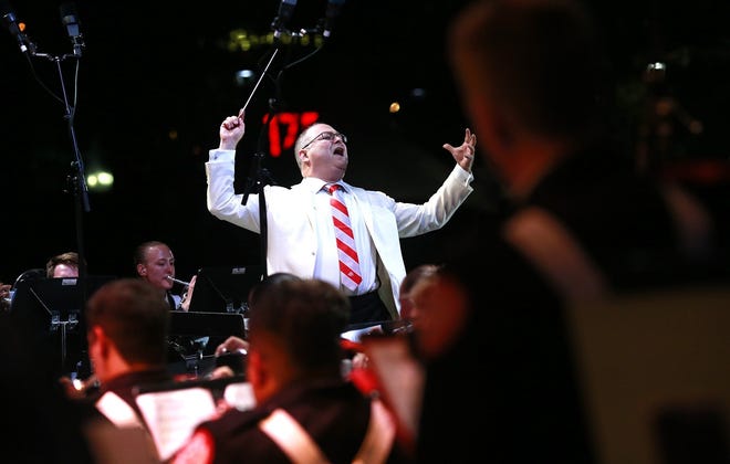 Maestro Stuart Chafetz conducts The Ohio State University Marching Band performance with the Columbus Symphony Orchestra at the Picnic with the Pops at the Columbus Commons in Columbus, Ohio on July 27, 2018. [ Brooke LaValley / Dispatch ]