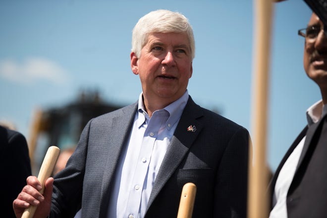 FILE - In this July 17, 2018 file photo, Michigan Gov. Rick Snyder fields questions during a ceremonial groundbreaking event for the Gordie Howe International Bridge in Detroit. Snyder is ordering the state to no longer ask job applicants and people seeking certain occupational licenses to check a box if they have been convicted of a felony. Snyder, who announced the changes on Friday, Sept. 7, 2018, said the box is being replaced with a statement by which applicants can affirm their good character. (Ben Allan Smith/Ann Arbor News via AP, File)