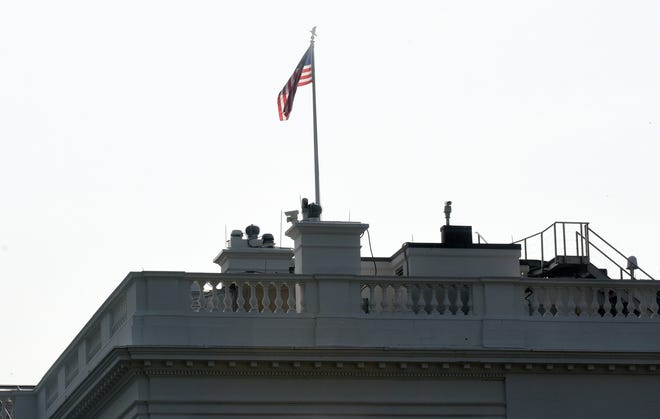 The White House flag is raised back to full-staff on Monday morning, Aug. 27, after one day at half-staff to honor the late Sen. John McCain. [Olivier Douliery/Abaca Press/TNS]