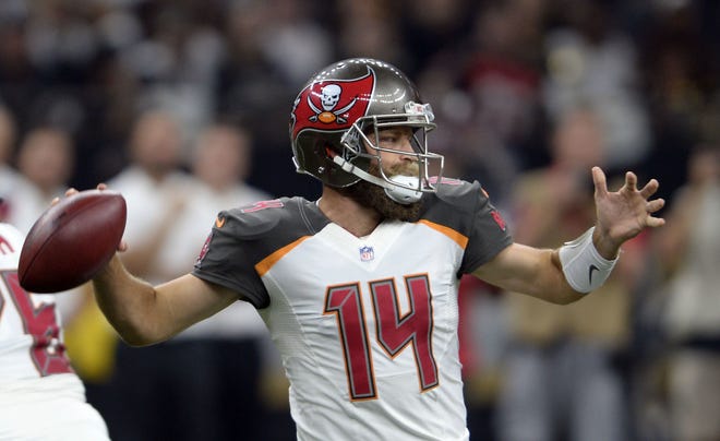 Tampa Bay Buccaneers quarterback Ryan Fitzpatrick (14) passes in the first half against the New Orleans Saints in New Orleans, Sunday. The Bucs defeated the Saints 48-40. [The Associated Press / Bill Feig]