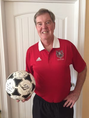 Palmetto assistant soccer coach Mike Meehan holds autographed ball presented to him by the 2015 Palmetto High soccer team that reached the regional final. [COURTESY PHOTO]