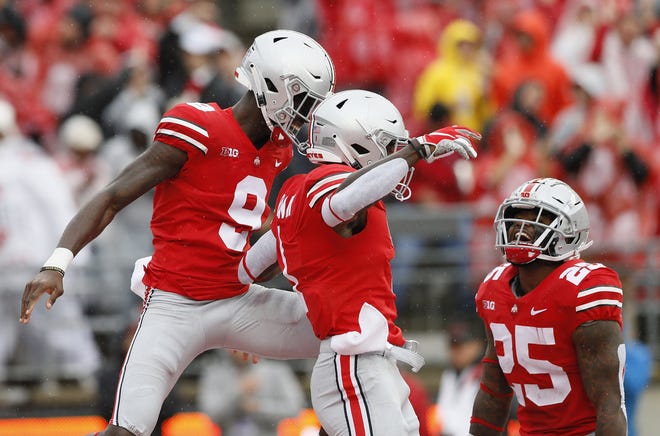 Ohio State Buckeyes wide receiver Binjimen Victor (9) and running back Mike Weber (25) congratulate wide receiver Johnnie Dixon (1) on scoring a touchdown during the NCAA football game against the Rutgers Scarlet Knights at Ohio Stadium in Columbus on Sept. 8, 2018. Ohio State won 52-3. [Photo by Adam Cairns]