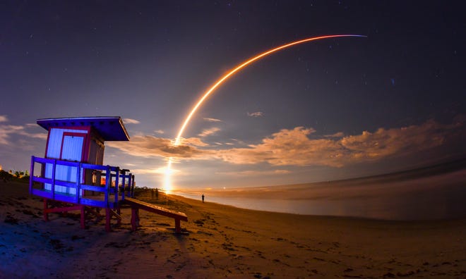 The launch of Telesat's Telstar 18 Vantage communications satellite on a SpaceX Falcon 9 rocket, launched from Launch Complex 40 at Cape Canaveral Air Force Station, is viewed from Minutemen Causeway in Cocoa Beach, early Monday, Sept. 10, 2018. Photo is a 145-second time exposure of the launch with life guard station in the foreground. (Malcolm Denemark/Florida Today via AP)