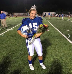 In this Friday, Sept. 7, 2018 photo provided by the Ocean Springs School District, Ocean Springs High School's 2018 Homecoming Queen Kaylee Foster holds her football helmet while wearing a tiara on the field in Ocean Springs, Miss. The high school senior was crowned homecoming queen before the football game where she kicked the winning field goal to lead her team to victory.