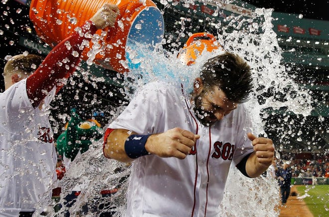 Mitch Moreland is doused by teammate Brock Holt after Moreland's game-winning RBI single in the ninth inning of Sunday's game against Houston.