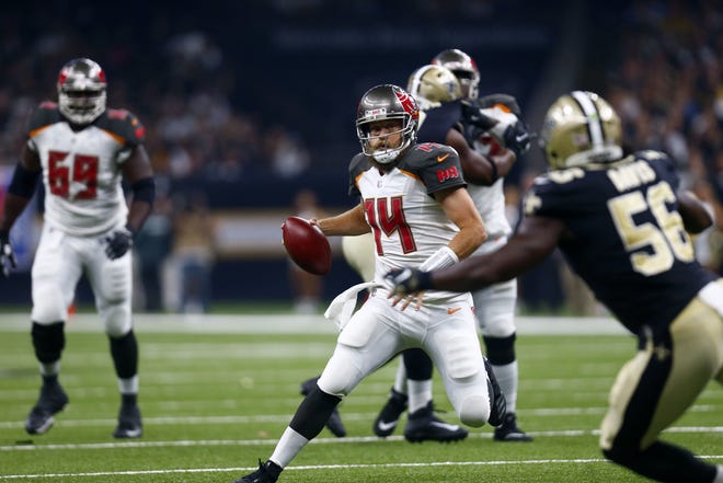 Tampa Bay Buccaneers quarterback Ryan Fitzpatrick (14) scrambles as New Orleans Saints linebacker Demario Davis (56) pursues in the first half in New Orleans, Sunday. The Bucs won 48-40. [The Associated Press / Butch Dill]