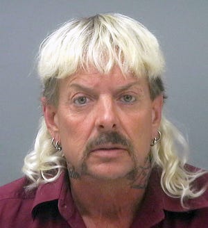 This photo provided by the Santa Rose County Jail in Milton, Fla., shows Joseph Maldonado-Passage, an Oklahoma zookeeper, who was indicted on federal murder-for-hire charges. Carole Baskin, the operator of a Florida-based animal sanctuary, says she was the target of Maldonado-Passage, who goes by the nickname "Joe Exotic." Maldonado-Passage, who remains jailed in Florida, also ran unsuccessfully for Oklahoma governor as a Libertarian this year. (Santa Rosa County Jail via AP)