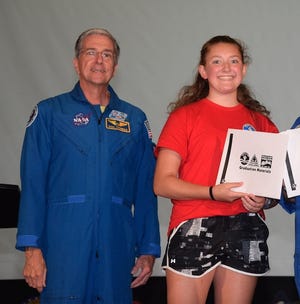 Riley Foye, right, of Billerica, standing with retired astronaut Dr. Don Thomas, graduates from Space Academy with honors at the U.S. Space and Rocket Center. [Courtesy Photo]