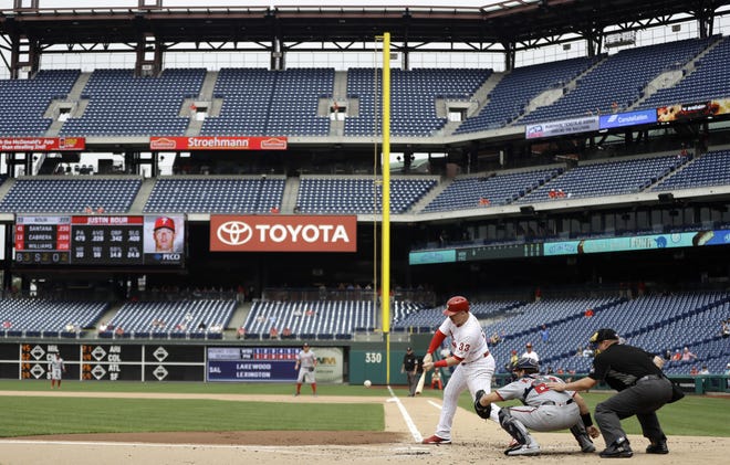 Phillies first baseman Justin Bour hits a double in the first inning of Tuesday's first game in front of a small crowd at Citizens Bank Park. [MATT SLOCUM/ASSOCIATED PRESS]