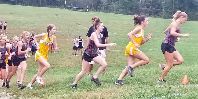 Runners make their way around the course during Tuesday's MVL cross country action in New Concord. The first three JG runners at this point in the race (right to left in dark uniforms) were Carleigh Ludwig, Courtlyn Shhowman and Sydney Johnson, but Johnson ended up winning in 20:35.
