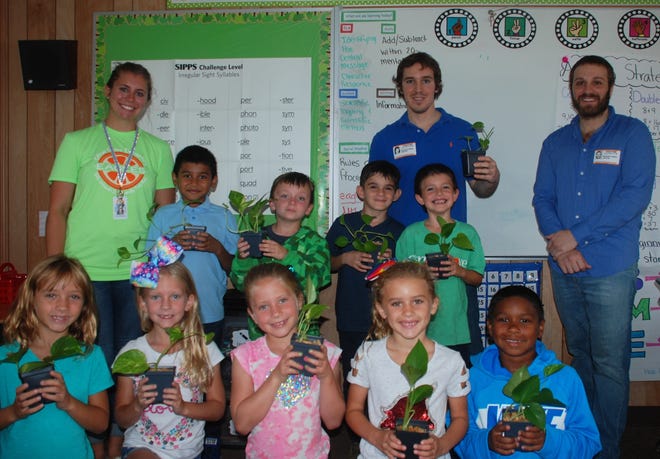 Russell and Garrett Collins of Peace by Peace gifted organic indoor air purifying pothos plants and seeds to Scotlan Severson's second grade class at Citrus Grove Elementary School in DeLand. Peace by Peace has gifted more than 1,000 plants to local students at 30 schools as part of 55 Green Classroom Initiative events. This is the beginning of the initiative's fourth year. For information, visit instagram.com/PeacebyPeaceUSA. [Photo provided]