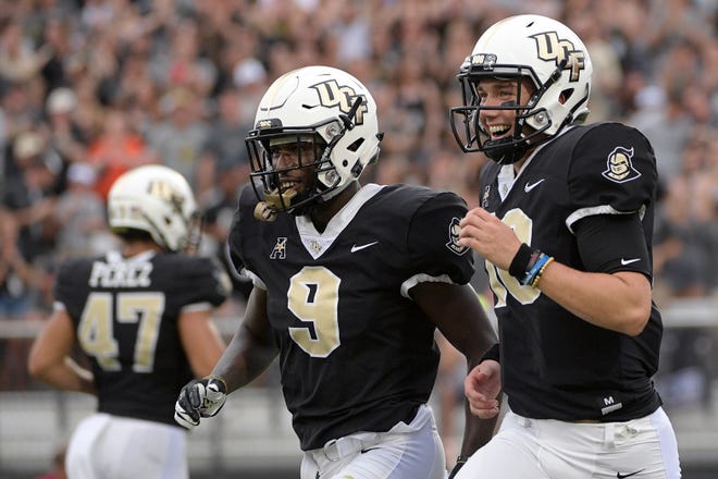 Central Florida running back Adrian Killins Jr. (9) and quarterback McKenzie Milton (10) and the rest of the Knights will be sidelined this weekend due to Hurricane Florence. (AP Photo/Phelan M. Ebenhack)