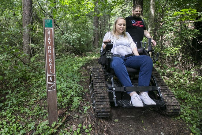 ARTURO FERNANDEZGATEHOUSE MEDIA ILLINOIS

Jenna Hammerly and her husband, Nick Hammerly, exit a nature trail at Kinnikinnick Creek Nature Preserve in Caledonia on Thursday, Sept. 6, 2018. Hammerly used an all-terrain outdoor wheelchair on loan to Hononegah Archery by Access Ability Wisconsin, the first of its kind available for public use in Illinois.