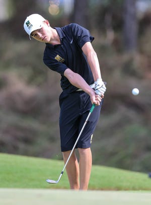 Nease's Logan Underwood chips onto the fifth green on Sept. 22, 2015 during his first year competing in the St. Johns County Boys Golf Tournament at Slammer & Squire Golf Course at World Golf Village. On Wednesday, the senior will compete in the tourney for the final time. [GARY LLOYD MCCULLOUGH/CORRESPONDENT]