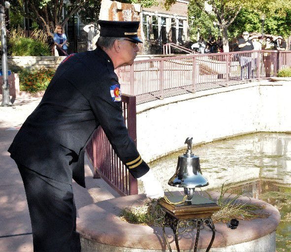 Capt. Jim Grimes of the Pueblo Fire Department rings a bell to commemorate the fall of the World Trade Center towers on Sept. 11, 2001. [Chieftain photo/Jon Pompia]