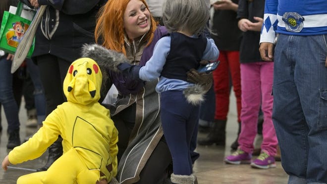 Jessica Luttrell, center, gets a hug from her daughters Sophia, 7, and Ellie, 4, after they competed in the costume contest as Pokemon and Lt. Judy Hopps during Wizard World Comic Con in 2017. Stephen Spillman for American-Statesman