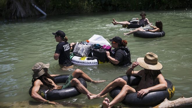 Texas Search & Rescue personnel wade past tubers during Float Fest 2018 on Sunday, July 22, 2018, in San Marcos, TX. Float Fest is an annual music festival where attendants enjoy live music, camping and floating on the river. AMANDA VOISARD/AMERICAN-STATESMAN
