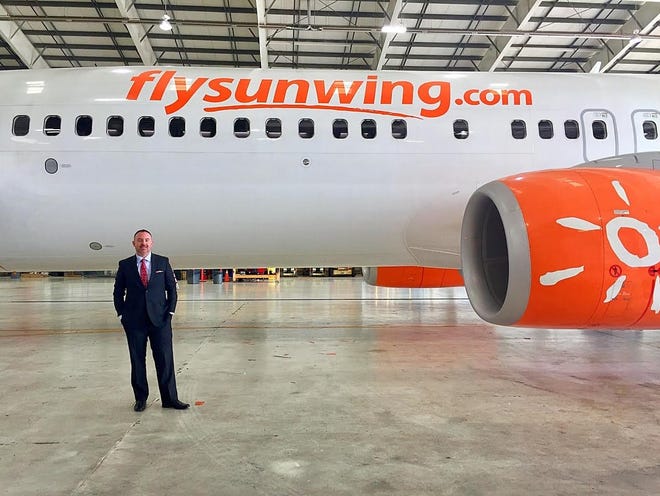 Jay Cassens, director of business development for Daytona Beach International Airport, pictured on Sept. 7, 2018, stands next to a Sunwing Airlines jetliner, similar to the one the Canadian airline plans to use when it launches its nonstop Toronto-Daytona Beach service in late January 2019. [Volusia County/Kate Sark]