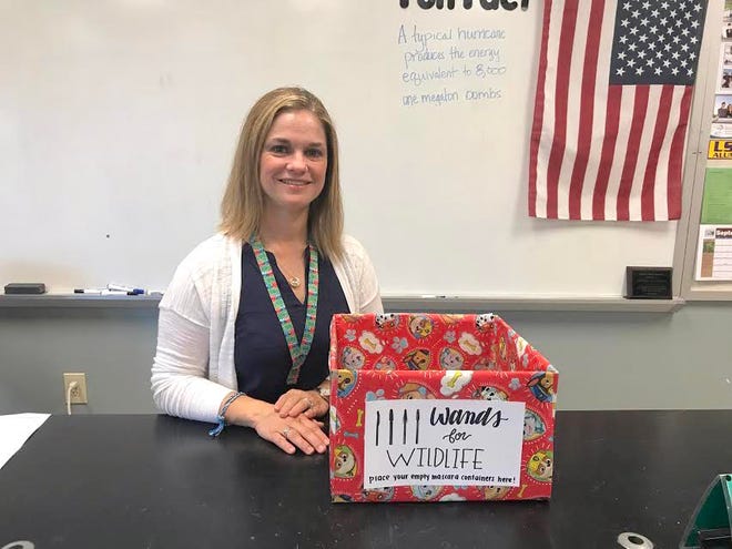 Lindsay Seely next to her classroom donation box.