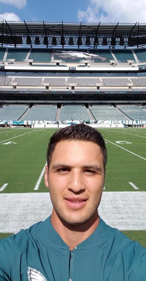 Salvador Robles-Soriano stands on the sidelines of the Philadelphia Eagles' stadium during his internship as a trainer. [Contributed]