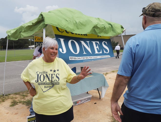 Cecilia Jones speaks with a supporter while campaigning outside the DeFuniak Springs on primary election day Aug. 28. [MICHAEL SNYDER/DAILY NEWS]