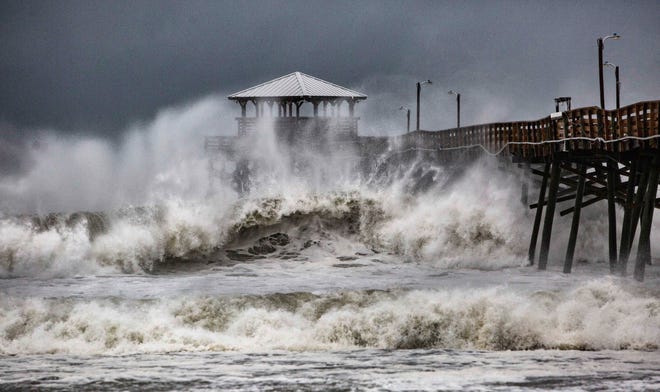 Waves slam the Oceana Pier & Pier House Restaurant in Atlantic Beach, N.C., Thursday, Sept. 13, 2018 as Hurricane Florence approaches the area. (Travis Long/The News & Observer via AP)