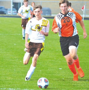 Cheboygan freshman midfielder Alex Clymer (right) chases for the ball with Ogemaw Heights' Alex Kennedy during a boys soccer matchup in Cheboygan on Thursday. Clymer scored the lone goal for the Chiefs in a loss to the Falcons.