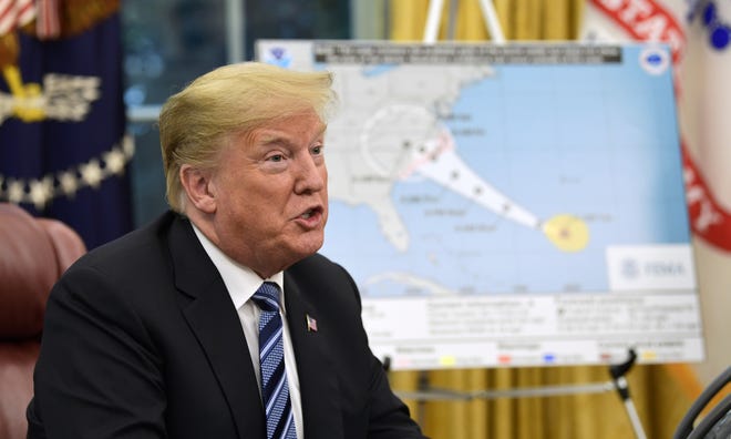 President Donald Trump talks about Hurricane Florence during a briefing in the Oval Office of the White House in Washington, Tuesday, Sept. 11, 2018. (AP Photo/Susan Walsh)