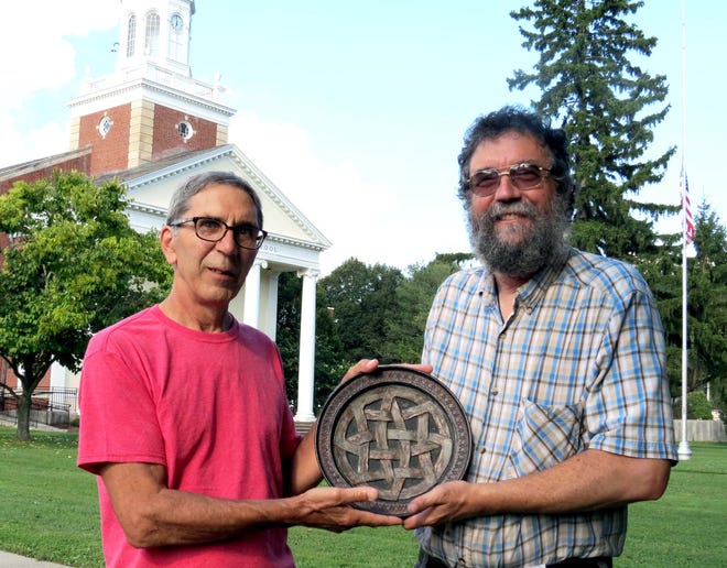 Richard Lang and Steve Walker, both alumni of Andover Central School, with a ceramic plate crafted by Lang in 1968. This and other examples of locally produced Celtic Art will be exhibited in Andover from Sept. 21-29. [PHOTO PROVIDED]