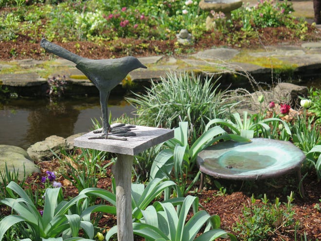 A good birdbath should be like a puddle, with gently sloping sides. A shallow dish that holds water is all you need. If your birdbath is a shallow dish like this, you'll want to fill it with fresh water every day. The birds will learn your routine and visit often. [MARTY ROSS VIA UNIVERSAL UCLICK]