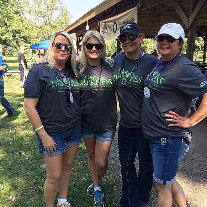TOM LOEWY/GATEHOUSE MEDIA ILLINOIS From left, Kathy Guldenzopf, Tina Benedict, Chastity Smith and Carolyn Landon enjoy a moment during the 2016 Out of the Darkness Walk at Lake Storey Park.