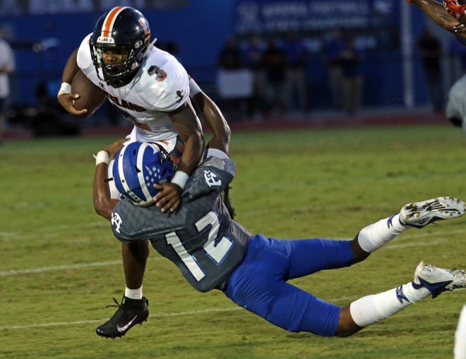 Lakeland running back Demarkcus Bowman is tackled by Apopka's Jaquan Lowman last week. [ROY FUOCO/THE LEDGER]
