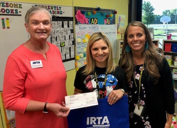 Donna Sargent, left, with Illinois Retired Teachers Association Foundation presents Heather Ramey, center and Principal/Superintendent Laura Irwin, right, with an award to help purchase additional books for students. [Photo submitted]