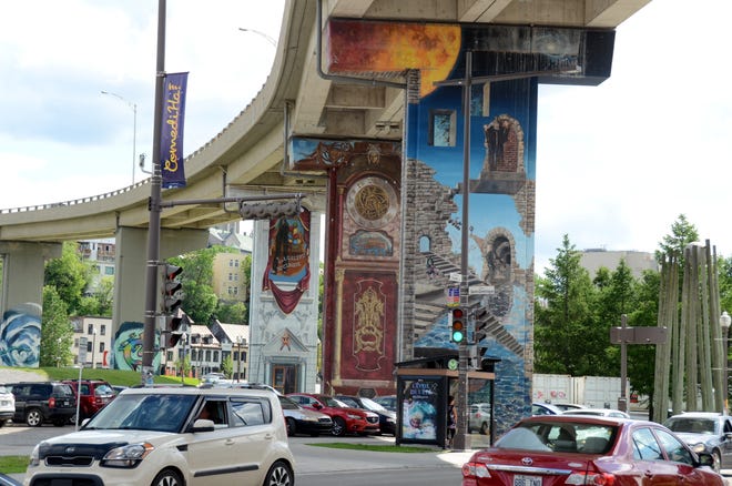 Motorists pass by street art under an elevated road in Quebec City, part of a neighborhood transformation meant to beautify a utilitarian stretch of the city. [AP / Calvin Woodward]
