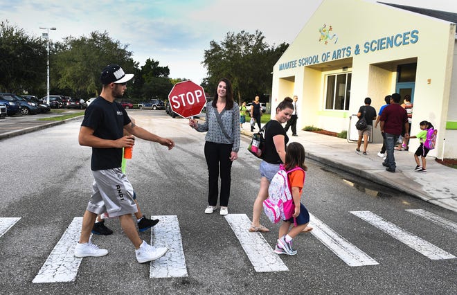Students and parents arrive at Manatee School of Arts and Sciences on the first day of class in this August 2016 file photo. [HERALD-TRIBUNE STAFF PHOTO / DAN WAGNER]