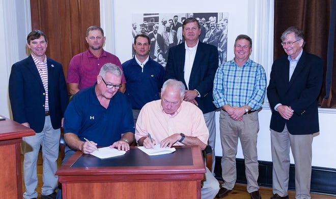 Babe Ruth League Senior Vice President Robert Flaherty (left) and Alabama Babe Ruth District Commissioner Arthur Evans sign contracts to bring the 2019 Babe Ruth Baseball 14-Year-Old World Series to Demopolis. Also in attendance at Rooster Hall were (back, from left) Rob Pearson (Host Committee), Walker Reynolds (director of the Demopolis Parks and Recreation), Seth Allgood (Host Committee), Dereck Morrison (Host Committee), Hugh Overmyer (Chairman of Demopolis Park and Recreation Board/Host Committee) and Demopolis mayor John Laney. [Photo/Michael Clements, The Alabama Watchman]
