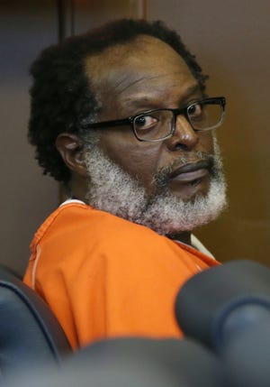 Stanley Ford looks around during a status hearing in Summit County Common Pleas Court on Friday in Akron. Ford is facing the death penalty. He is accused of setting two fires that killed nine people. [Mike Cardew/Beacon Journal/Ohio.com]