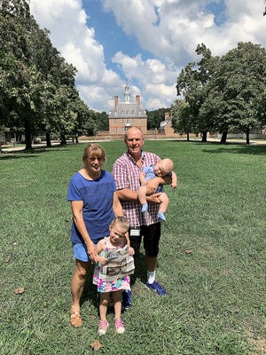 Taking the Review on vacation to Colonial Williamsburg are Douglas and Mary Anderson with grandchildren Jocelyn and Jordan Young.