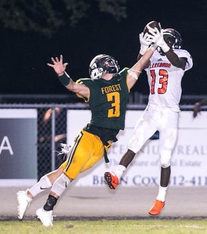 Forest's Chase Oliver breaks up the pass intended for Leesburg's Jatavian Solomon on Friday. [Cyndi Chambers/Ocala Star Banner Correspondent]