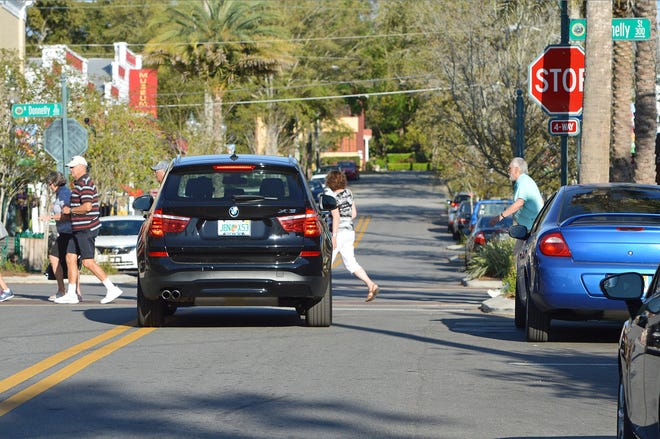 Pedestrians cross Fourth Avenue in downtown Mount Dora earlier this year. The city moved closer to buying land to create more parking for visitors to the downtown area. [Whitney Lehnecker/Daily Commercial]