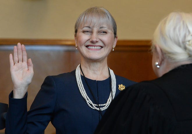 U.S. Magistrate Judge Susan Paradise Baxter smiles after being sworn in as a U.S. District Judge by Chief U.S. District Judge Joy Flowers Conti, right, in a brief ceremony at the Federal courthouse in Erie on Friday. [GREG WOHLFORD/ERIE TIMES-NEWS]