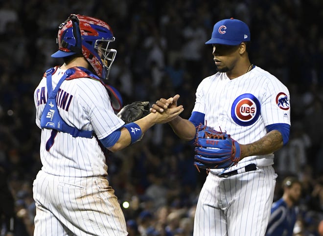Chicago Cubs catcher Victor Caratini (7) and relief pitcher Pedro Strop (46) celebrate their 3-0 win against the Milwaukee Brewers on Tuesday. [AP Photo/David Banks]
