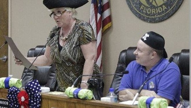 Lake Worth Mayor Pam Triolo proclaims International Talk Like a Pirate Day in Lake Worth in 2013 at the start of a commission meeting. Commissioner Andy Amoroso listens at right. (Damon Higgins/The Palm Beach Post)