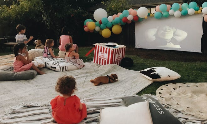 Setting up an outdoor movie theater has gotten easier and more affordable, AV experts say. [Rozalyn Schlumpf/Wittybash.com via AP]